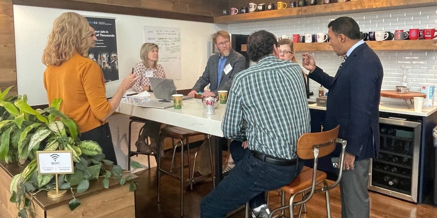 People in conversation at an Academic Impressions conference