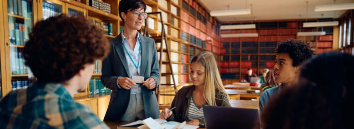 Librarian talking to students in the library